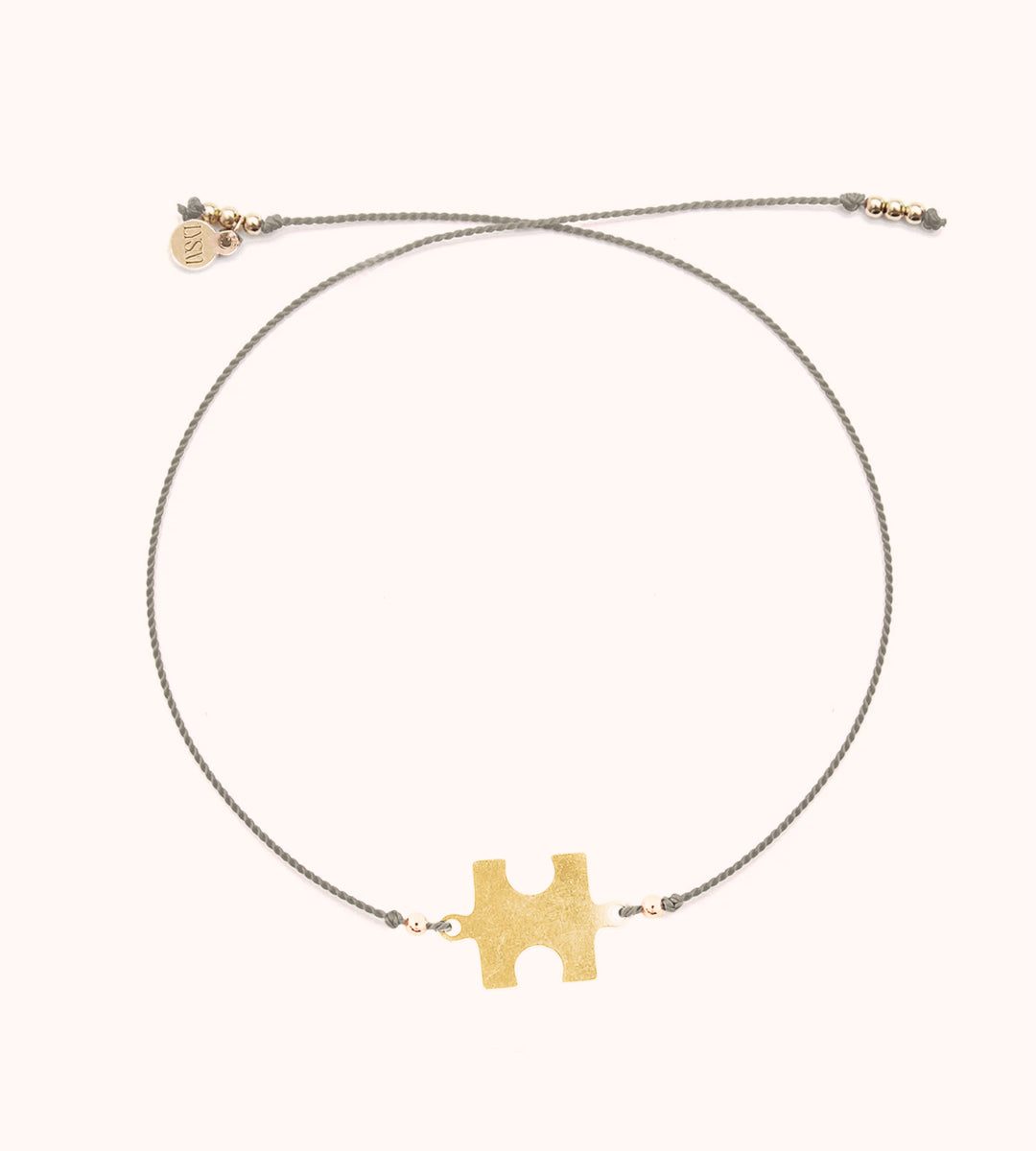 Glücksarmband mit einem Puzzel - Symbol der Solidarität und Zusammengehörigkeit