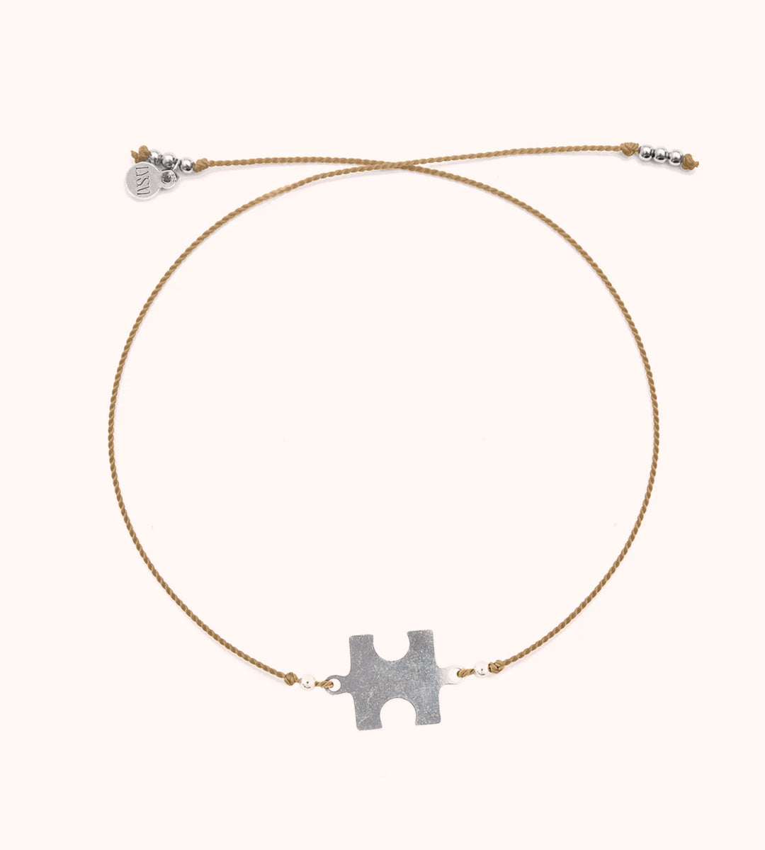 Glücksarmband mit einem Puzzel - Symbol der Solidarität und Zusammengehörigkeit